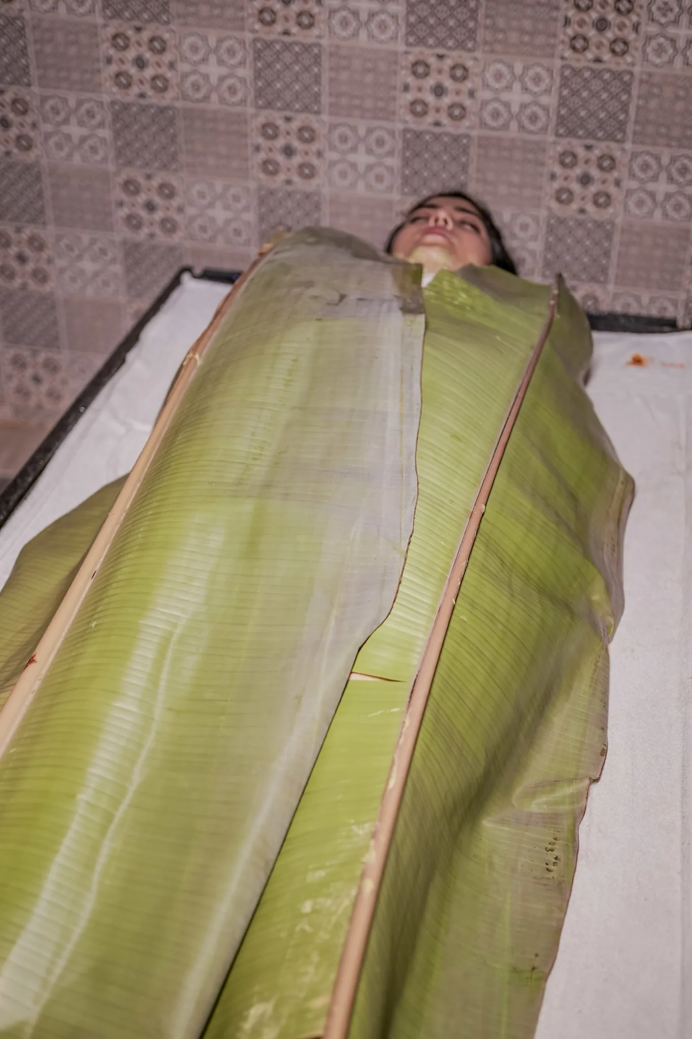 Woman relaxing during Banana Leaf Spa therapy at E Spa International