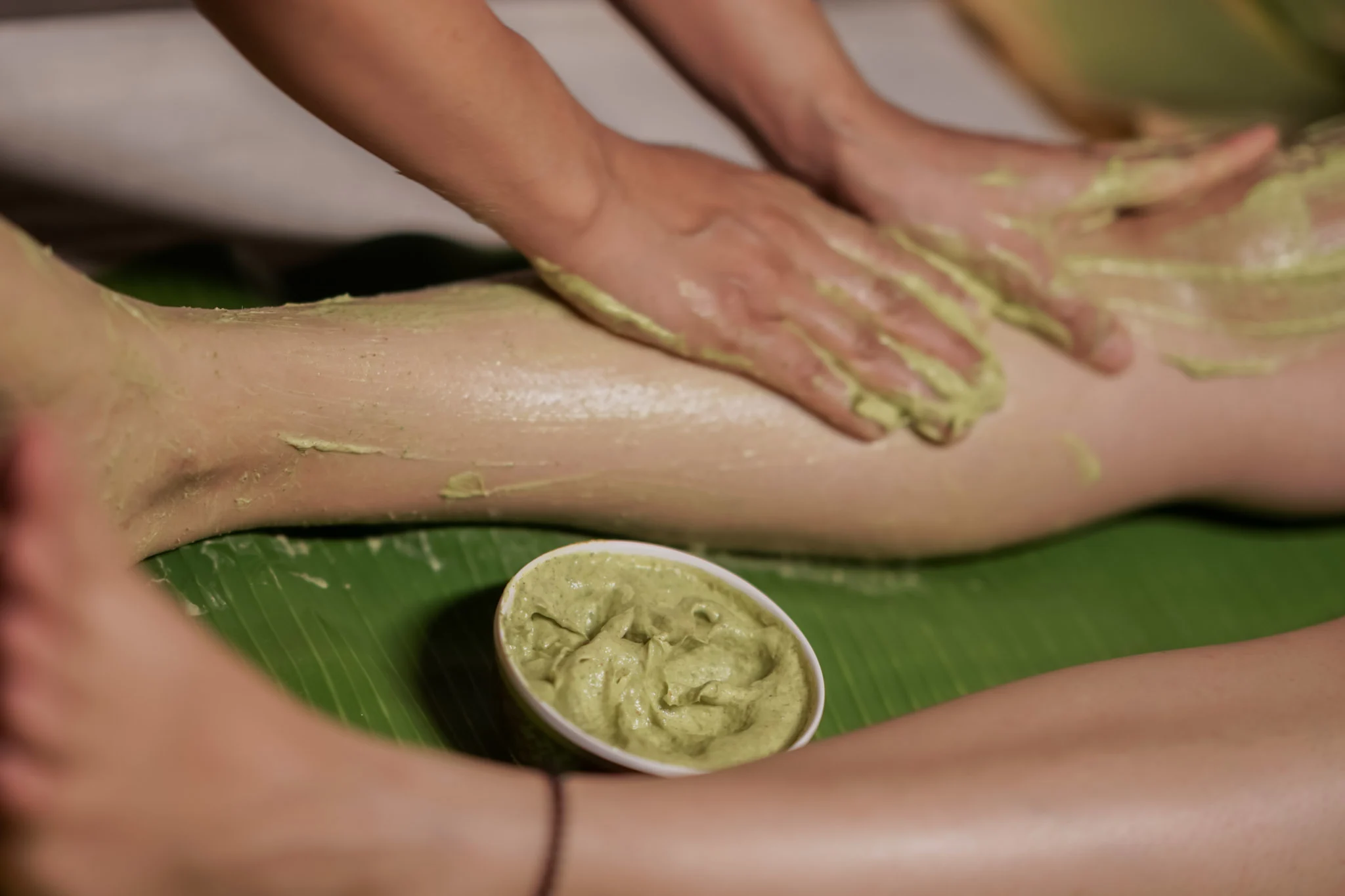 Herbal detox with warm banana leaf treatment in serene spa setting