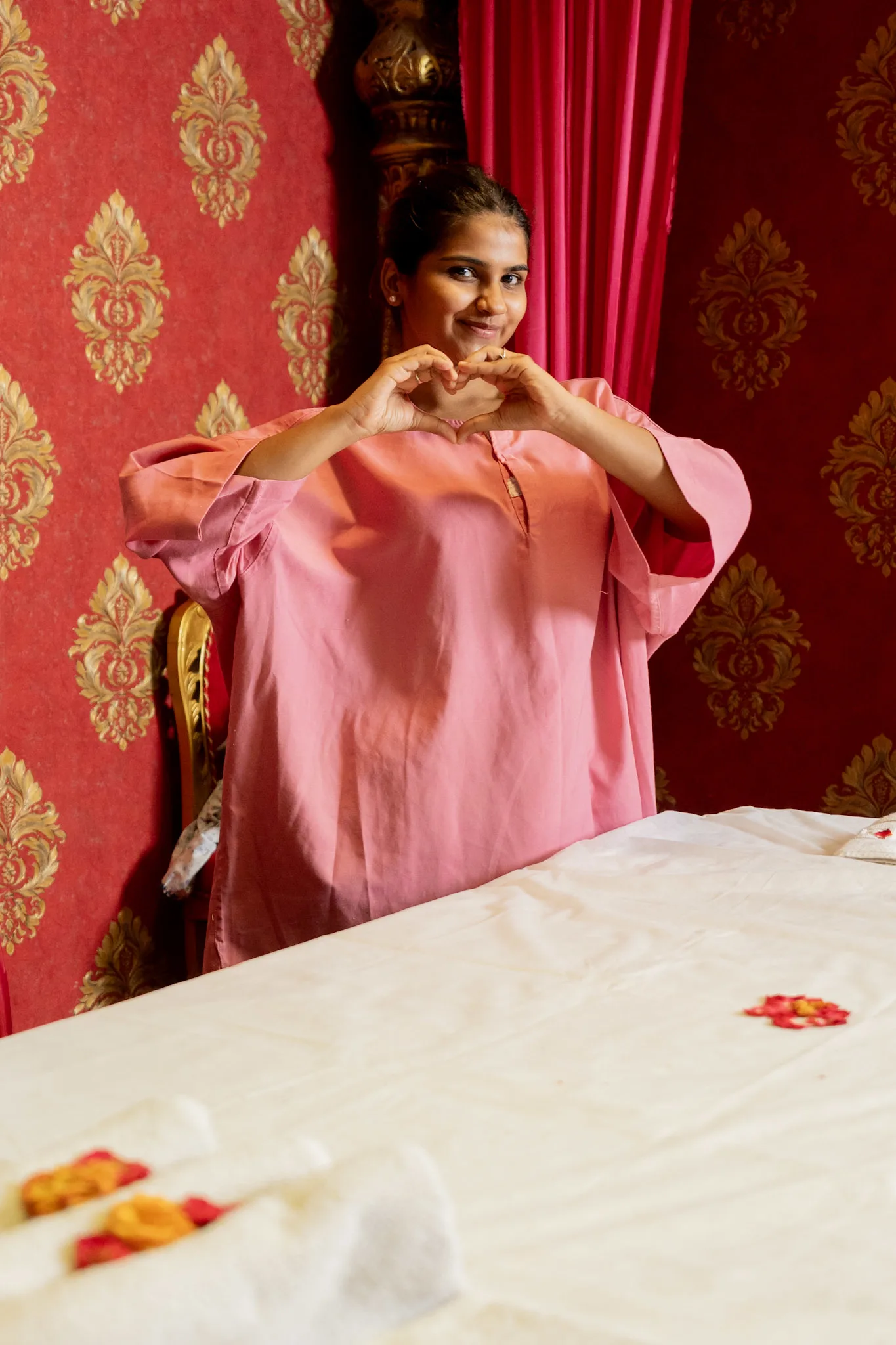 Happy guest making a heart symbol after spa treatment at E Spa International.